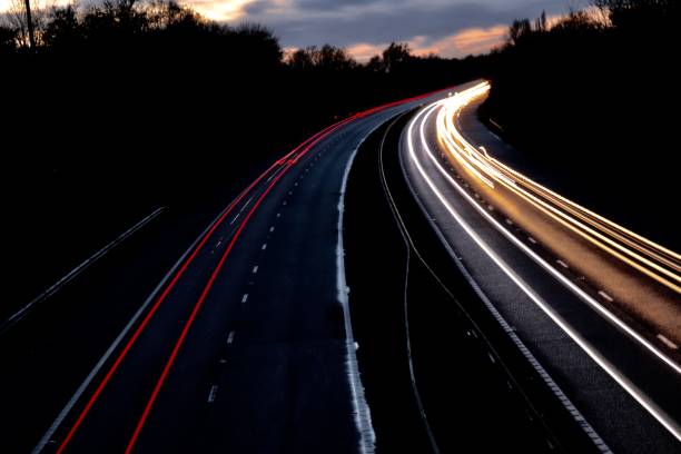 istock Motorway north and south bound car trail light 1065894350