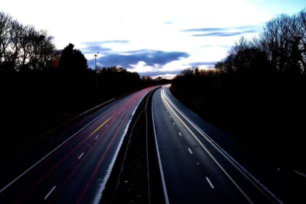 istock Motorway north and south bound car trail light 1065894360