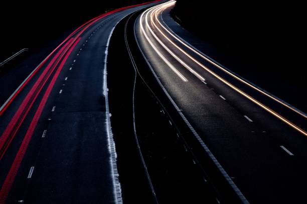 istock Motorway north and south bound car trail light 1065894364