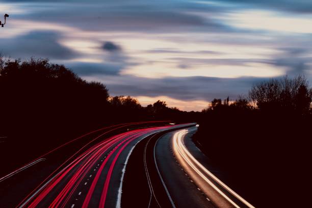 istock Motorway north and south bound car trail light 1065894370