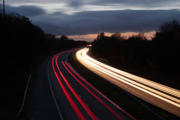 istock Motorway north and south bound car trail light 1065894396