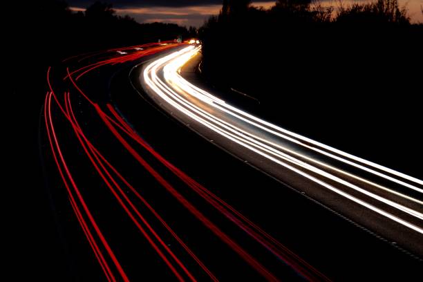 istock Motorway north and south bound car trail light 1065894428