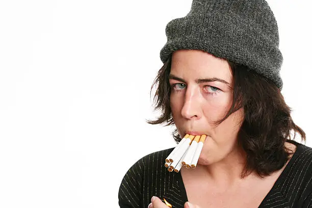 young woman with lot´s of cigarettes in her mouth