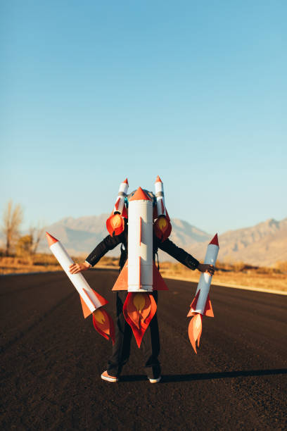 istock Business Boy Holding Rockets 1065901786