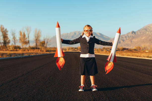 istock Business Girl Holding Rockets 1065901842