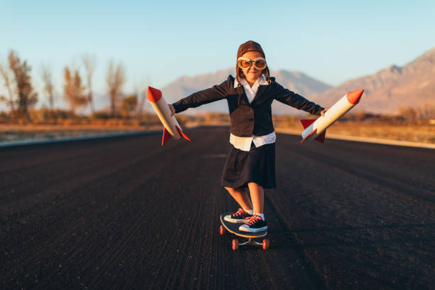 junge mädchen fahren skateboard mit raketen - taking off business creativity adventure stock-fotos und bilder