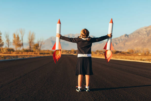 istock Business Girl Holding Rockets 1065901920