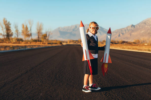 istock Young Business Girl Holding Rockets 1065901992