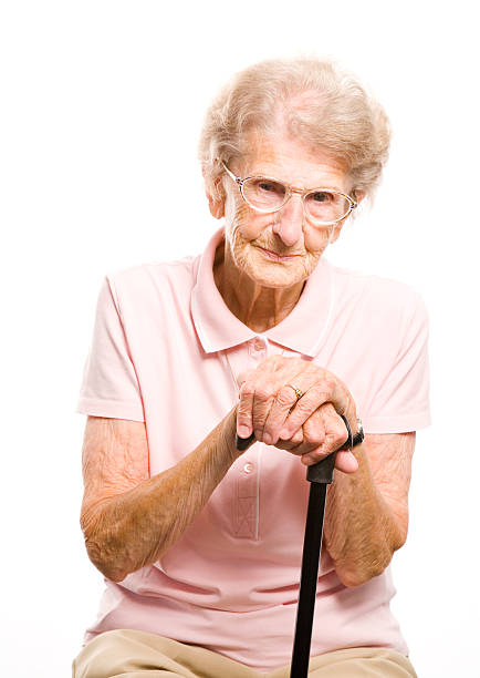 istock senior woman with her walking stick 106590302