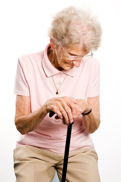 istock senior woman with her walking stick 106590310
