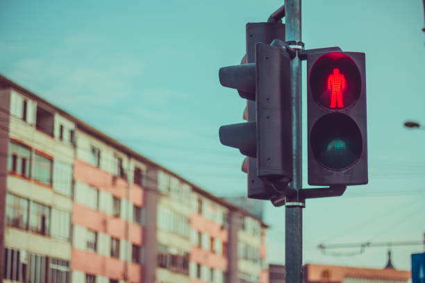 istock Semaphore for pedestrians with red stop sign lit 1065904584