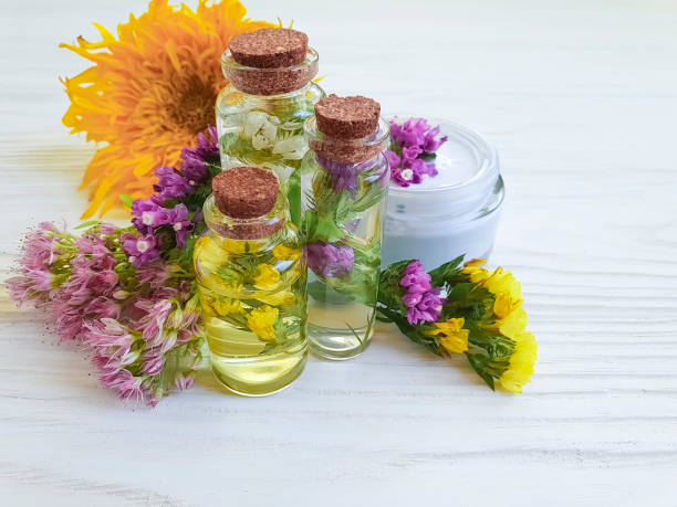 istock cosmetic cream, flower extract on wooden background 1065909494