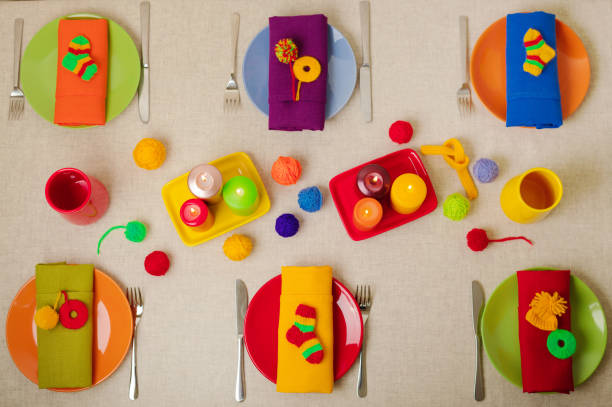 istock Multicolored plates and linen napkins with knitted decor. Table setting for the autumn or winter cold season - Thanksgiving, Halloween, Christmas and New Year. 1065911936