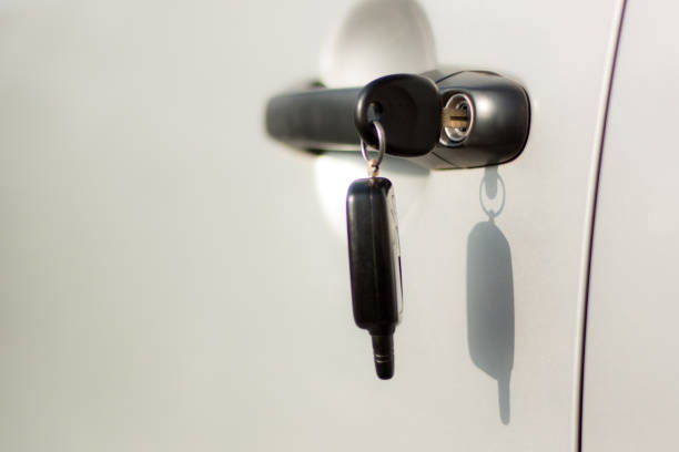 Concept of car security. Car key with remote lock connected on it. selective focus