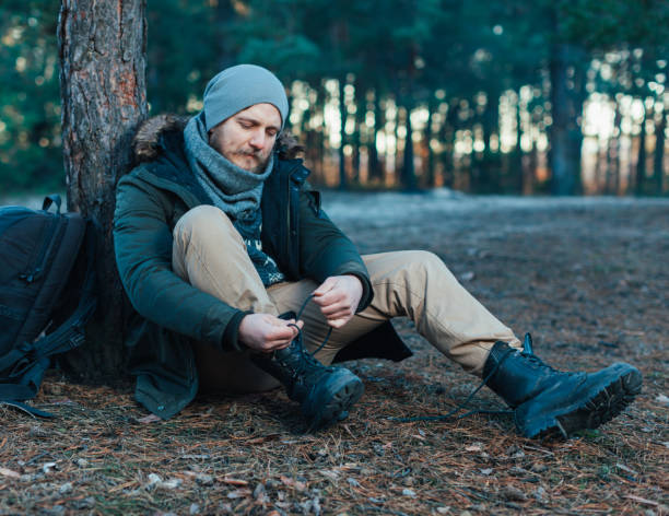 istock Pensive hipster guy wanderlust with touristic backpack enjoy tranquility during exploring nature environment, 1065917106