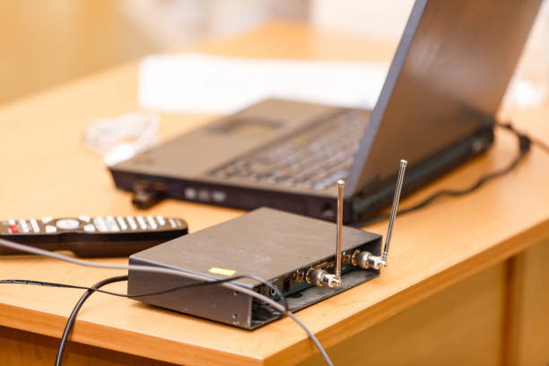 istock Black poles wifi router on the white table with wifi and computer icon 1065925970