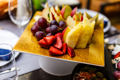 Close up fruit salad strawberries kiwi pineapple and raspeberries on plate