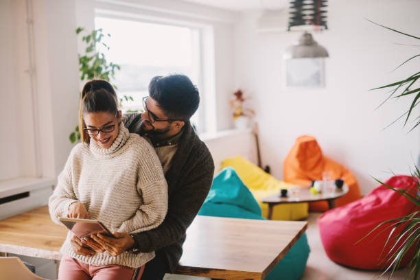 istock Couple looking at tablet while leaning on the table. Home interior. 1065926218