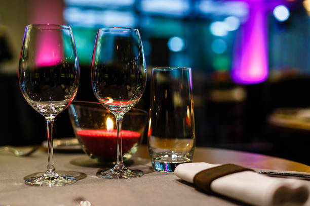 istock Two spare glasses and candle light at the restaurant 1065932106