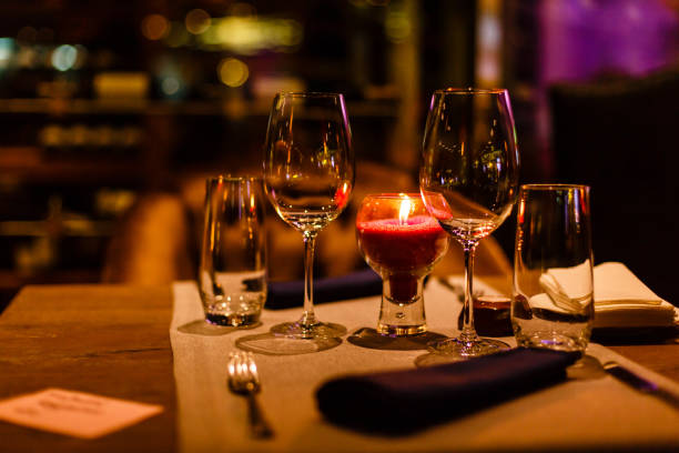 istock Two wine glasses and defocused lights at the restaurant 1065932118