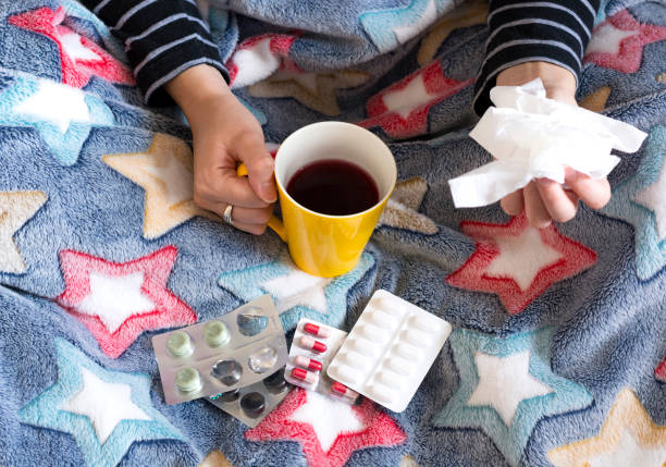 istock Sick woman with cup of tea 1065941402