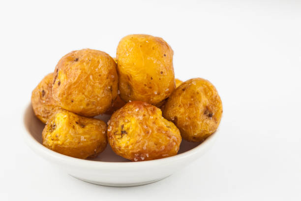 Fried yellow potatoes (Solanum phureja) isolated in white background