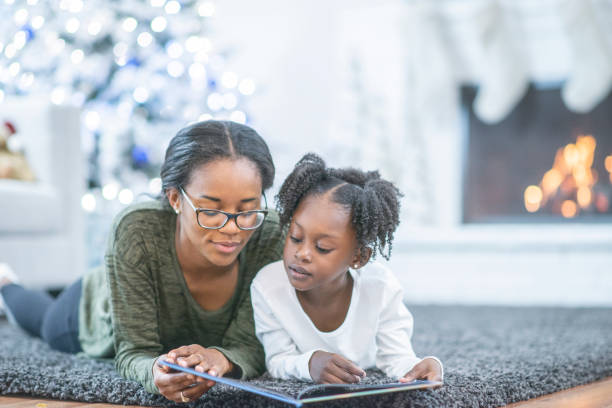 istock Little girl reading with her mom 1065950428