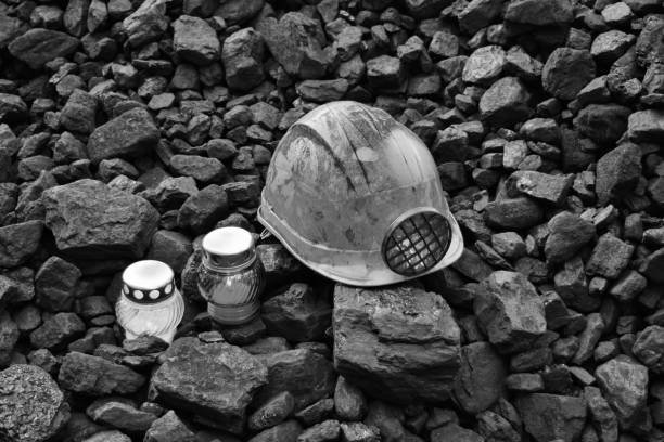 istock Vigil light, candle with mining helmet on cheap of coal 1065952282
