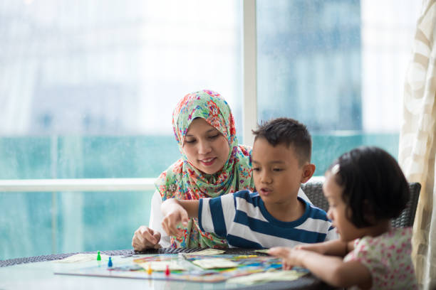 Mom playing a board game with her kids