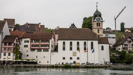 Eglisau, Switzerland - May 19, 2018: View of the old church, which is still in operation and the historic old town of the municipality Eglisau in the canton of Zurich in Switzerland.