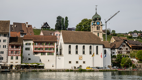 Eglisau, Switzerland - May 19, 2018: View of the old church, which is still in operation and the historic old town of the municipality Eglisau in the canton of Zurich in Switzerland.