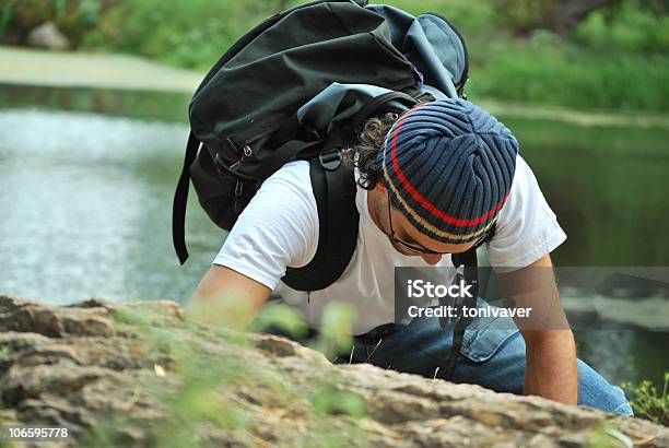 Young White Man Climbing A Steep Wall In Mountai Stock Photo - Download Image Now - Adult, Adults Only, Adventure