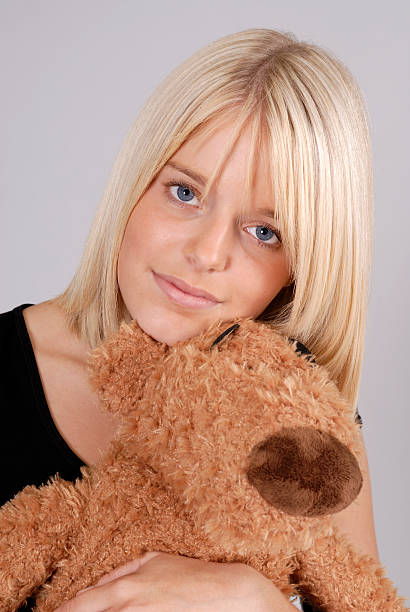 istock beautiful young blond woman with teddy bear 106595785