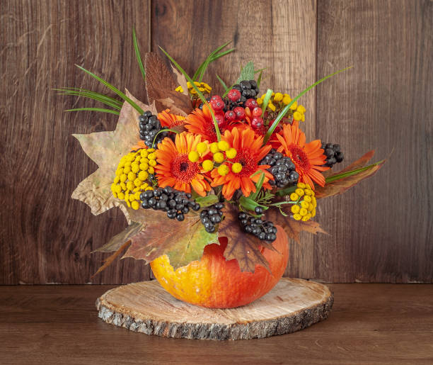 istock Flowers Bouquet in a Pumpkin Vase. 1065959634