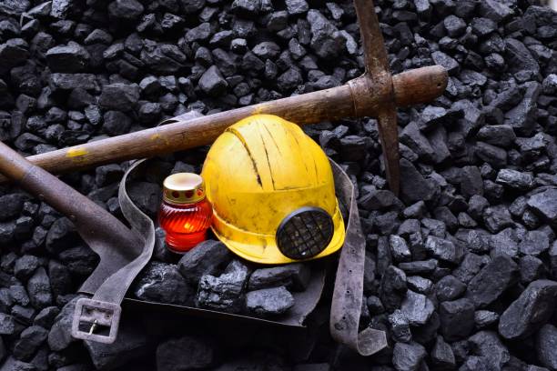 istock Vigil light, candle with the miner belongings (helmet, pickaxe, shovel, belt) 1065961134