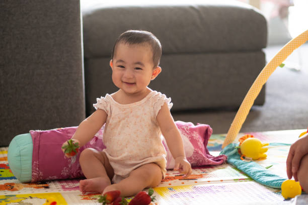istock Cute 6 month old baby with strawberries 1065963940