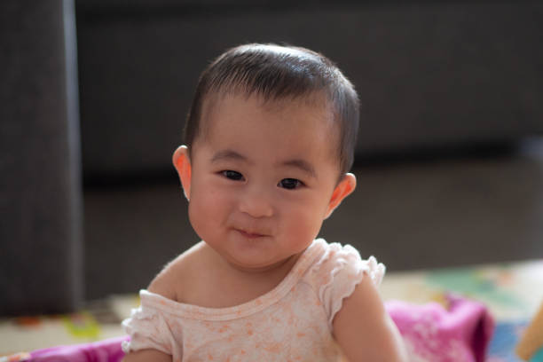 istock Cute 6 month old baby with strawberries 1065964394