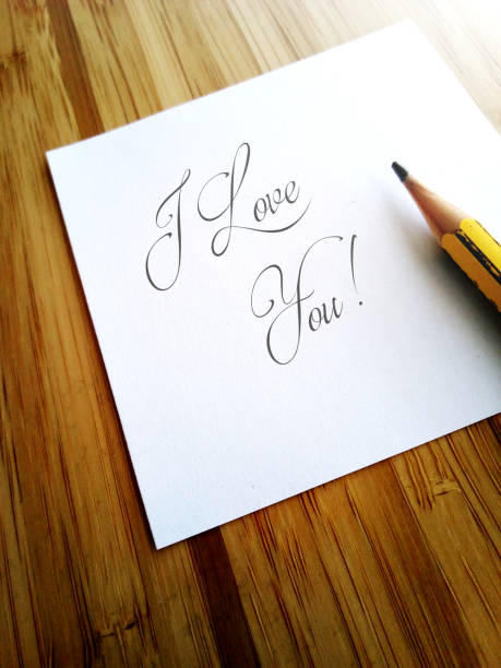 istock Handwritten message I Love You on white paper note 1065969008