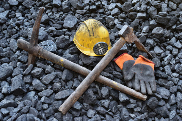 istock Vigil light, candle with the miner belongings (helmet, gloves, pickaxe) 1065969382