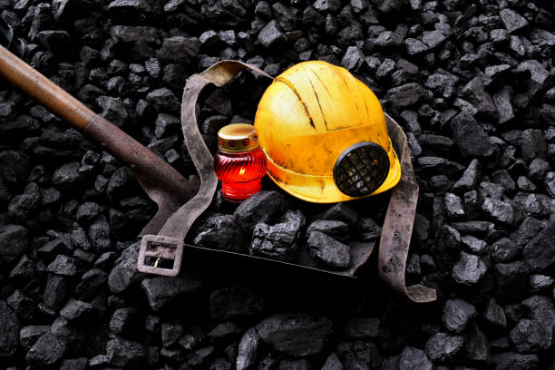 istock Vigil light, candle with the miner belongings (helmet, shovel, belt) 1065971802