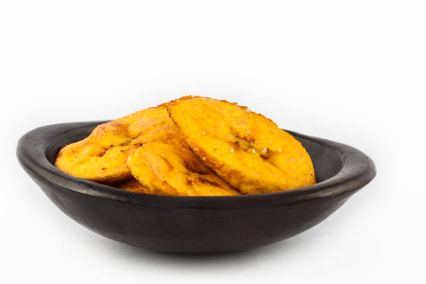 istock Fried half ripe plantain slices isolated on white background 1065974068
