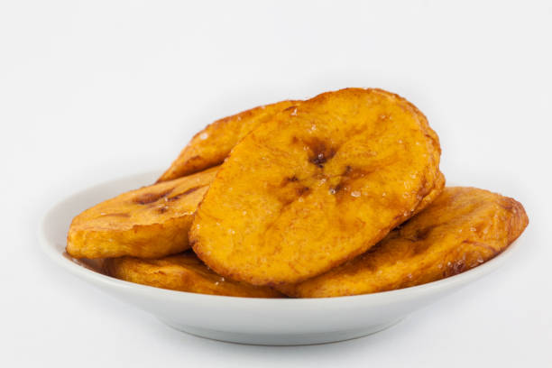 istock Fried half ripe plantain slices isolated on white background 1065974268
