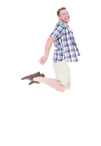 istock Handsome man in shirt and shorts and jumping with excitement 1065976324