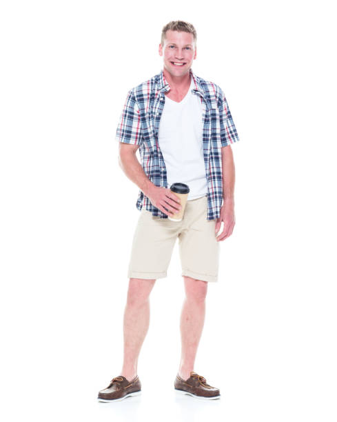 istock Handsome man in shirt and shorts holding a coffee cup 1065976374