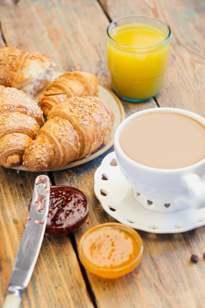 istock Black coffee and croissant with jam. Typical French Breakfast (Petit DÃ©jeuner) background. 1065978876