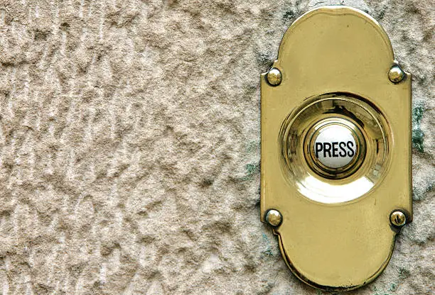 Photo of doorbell on brass plate