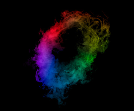 Round rainbow smoke puff isolated on black background