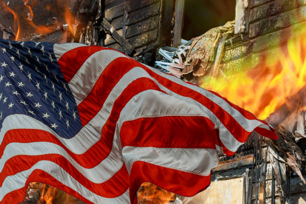 istock Fire burning in the engulfs small house and the American Flag 1065993688