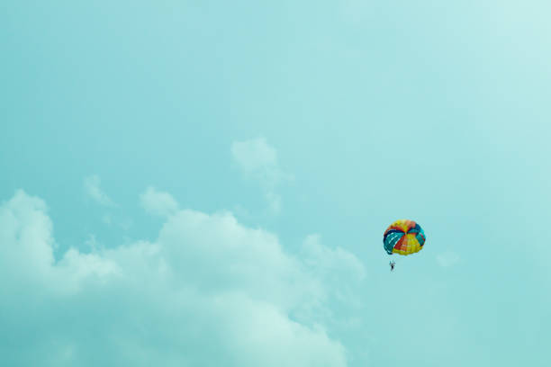 Skydiver flying with a colorful parachute