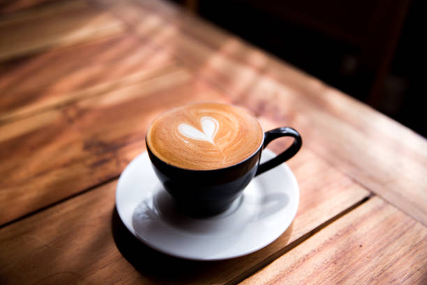 istock Cappuccino cup with heart latte art on wooden table background. 1066002202